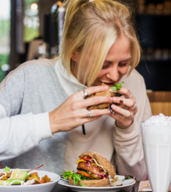 Blonde woman eating burger